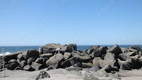 Brothers Climbing Rocks at Beach in Venice, CA photo