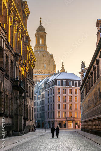 Couple walks hand in hand along the Furstenzug street early in the morning in Dresden, Germany.