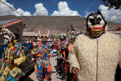 Revellers in costumes and masks at Humahuaca carnival in Jujuy province in the Andes region of Argentina, South America photo