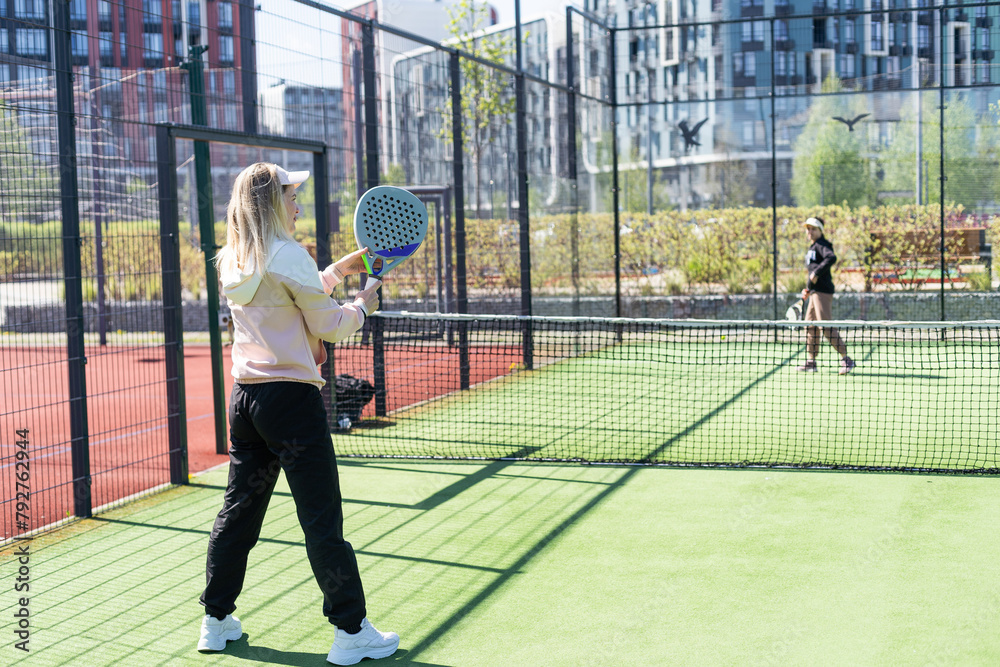 One women playing Paddle tennis One women playing Paddle tennis