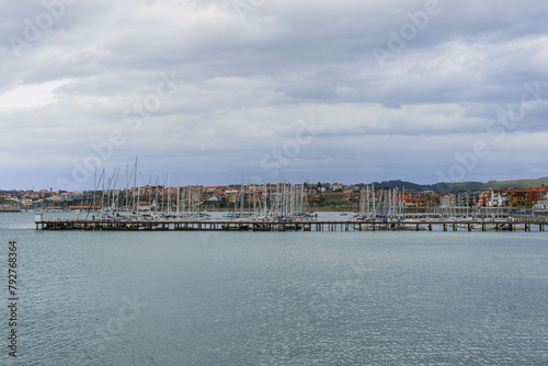 view of the old town with big river in center and colorful houses on cloudy day in bilbao photo