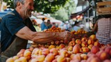 An elderly man carefully choosing ripe peaches at a bustling market stall
