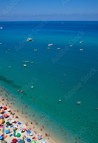 Sea beach with turquoise water and sand where people relax © Alekss