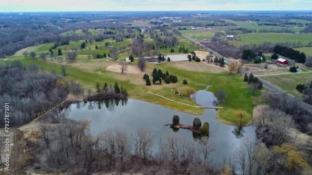 aerial flyover of a golf course in the countryside with a lake during spring (Wisconsin) aerial flyover of a golf course in the countryside with a lake during spring (Wisconsin)