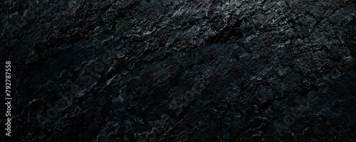 Black stone background with spotlight. Rough rock surface texture material.