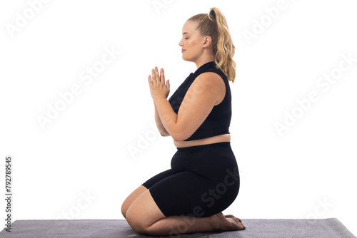 Caucasian plus-size young woman in black does yoga on a white background, copy space