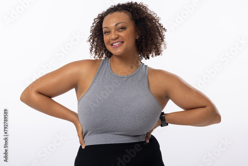 A biracial young female plus size model poses on white background