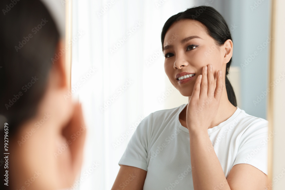 Portrait of beautiful woman near mirror indoors Portrait of beautiful woman near mirror indoors
