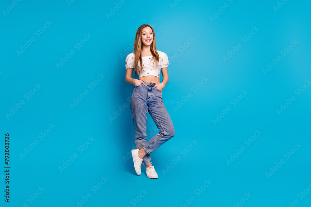 Photo of positive girl stand look in camera isolated blue color background