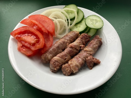 Cooking cevapchichi Balkan meat sausages photo