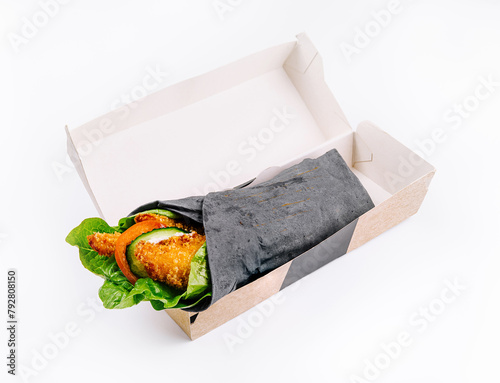 Fresh veggie wrap in takeout box on white background