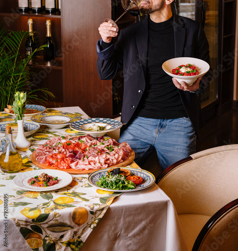 Man enjoying a feast of italian dishes