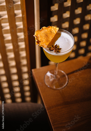 Elegant cocktail with garnish on wooden table photo