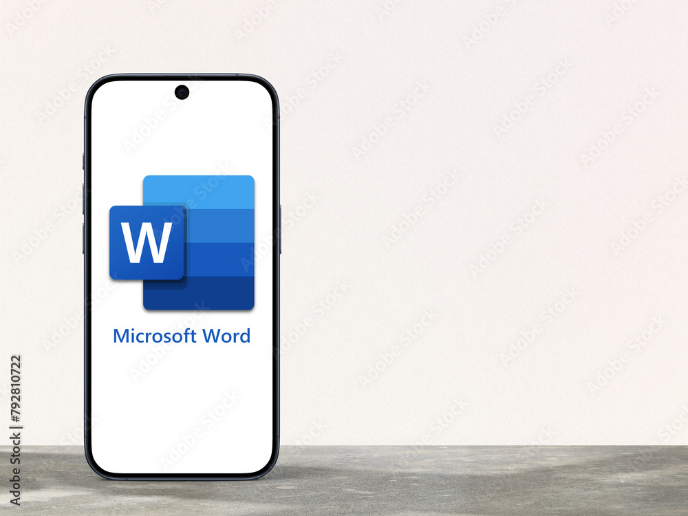 Microsoft Word Logo is displayed on a modern smartphone standing on a Microsoft Word Logo is displayed on a modern smartphone standing on a