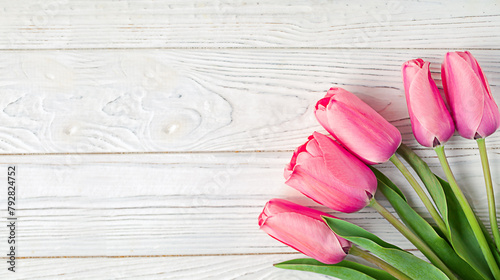 Spring time concept. Top photo of fresh pink tulip flowers on white wooden background with copy space