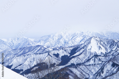 Mountain peak white snow in winter landscape in Japan. Awesome Beautiful Mountain tourism vacation. Great place for winter sports. Suitable for tourists and visiting citizens. Fog covered dark sky. 