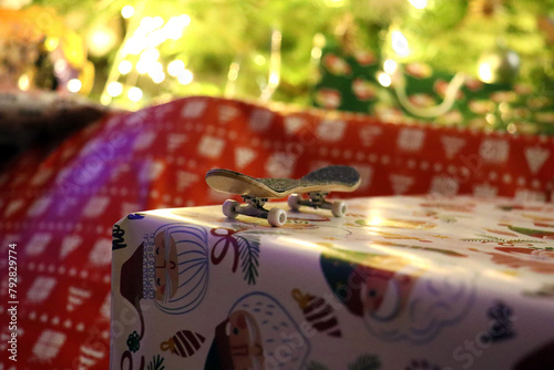 Wooden fingerboard at christmas gift. Mini skateboard, small skateboard deck