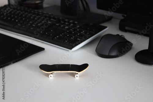 Wooden fingerboard at the ramp on table, close up. Mini skateboard, small skateboard deck