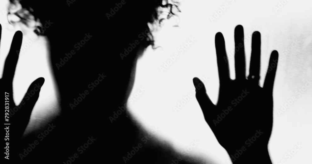 Silhouette of Person Leaning on Foggy Glass, Hands Pressed in Despair, Overcome by Depression, concept of mental illness feel desperate and alone during challenging times Silhouette of Person Leaning on Foggy Glass, Hands Pressed in Despair, Overcome by Depression, concept of mental illness feel desperate and alone during challenging times
