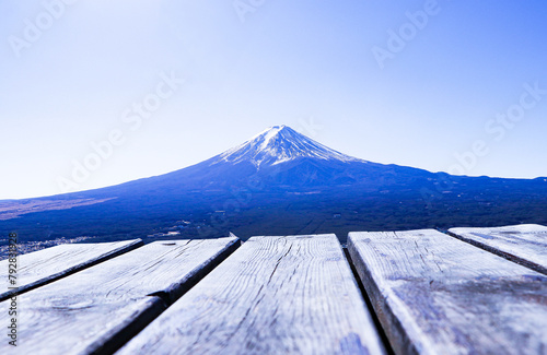 Abstract Texture background. Empty blank wood plank or brown table with Mount Fuji world famous tourist attractions. Beautiful Fuji mountain with snow cover on top with Bright blue sky, bright.