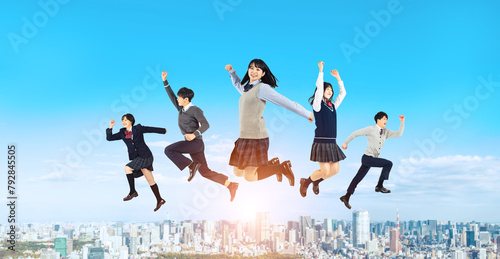都市を背景にジャンプする学生のグループ