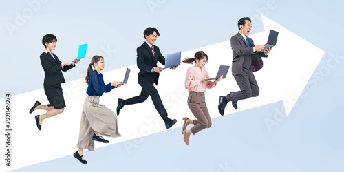 ノートパソコンを見ながらジャンプするビジネスパーソンのグループ（切り抜き背景透過PNGも販売しております。作成者リンクから「PNG」で検索してください） photo