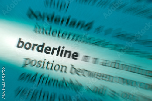 Borderline - only just acceptable in quality or as belonging to a category. A boundary separating two countries or a division between two distinct or opposite things. photo