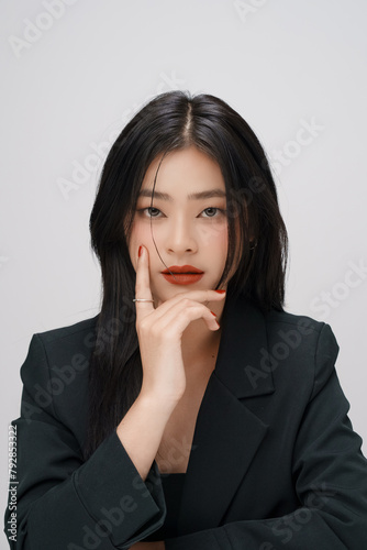 Gorgeous Young Asian female close up face with perfect make-up and red lips. Beautiful woman in black suits  look confidence and charming.