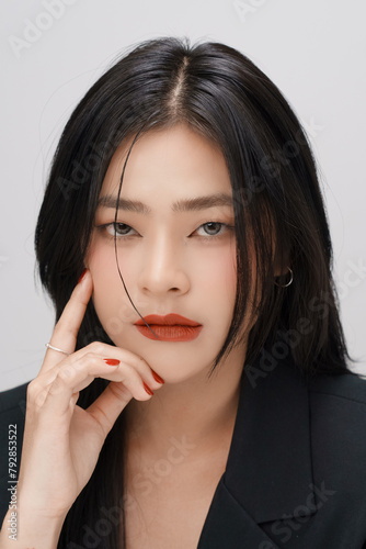 Gorgeous Young Asian female close up face with perfect make-up and red lips. Beautiful woman in black suits  look confidence and charming.