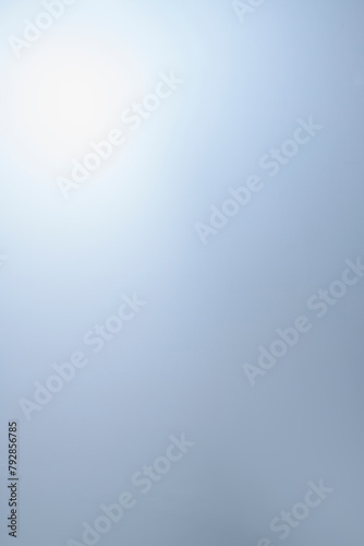 Gently blue background with a light gradient area. Vertical