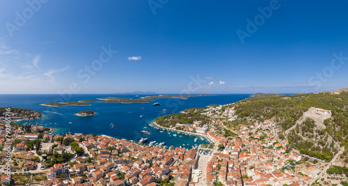 Hvar, Croatia: Aerial panorama of the famous Hvar island and old town with the yachts harbor and the Spannish fortress in Croatia on a sunny summer day and the Pakleni Islands in the background photo