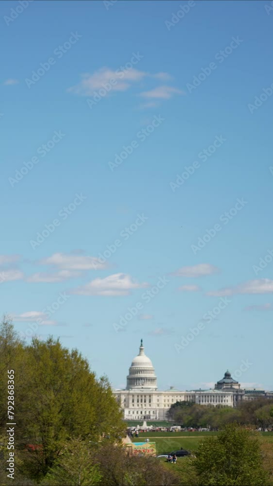 Vertical video of the US Capitol from the Washington Monument in Washington DC with sunny clear blue sky on spring summer day. . High quality 4k footage Vertical video of the US Capitol from the Washington Monument in Washington DC with sunny clear blue sky on spring summer day. . High quality 4k footage