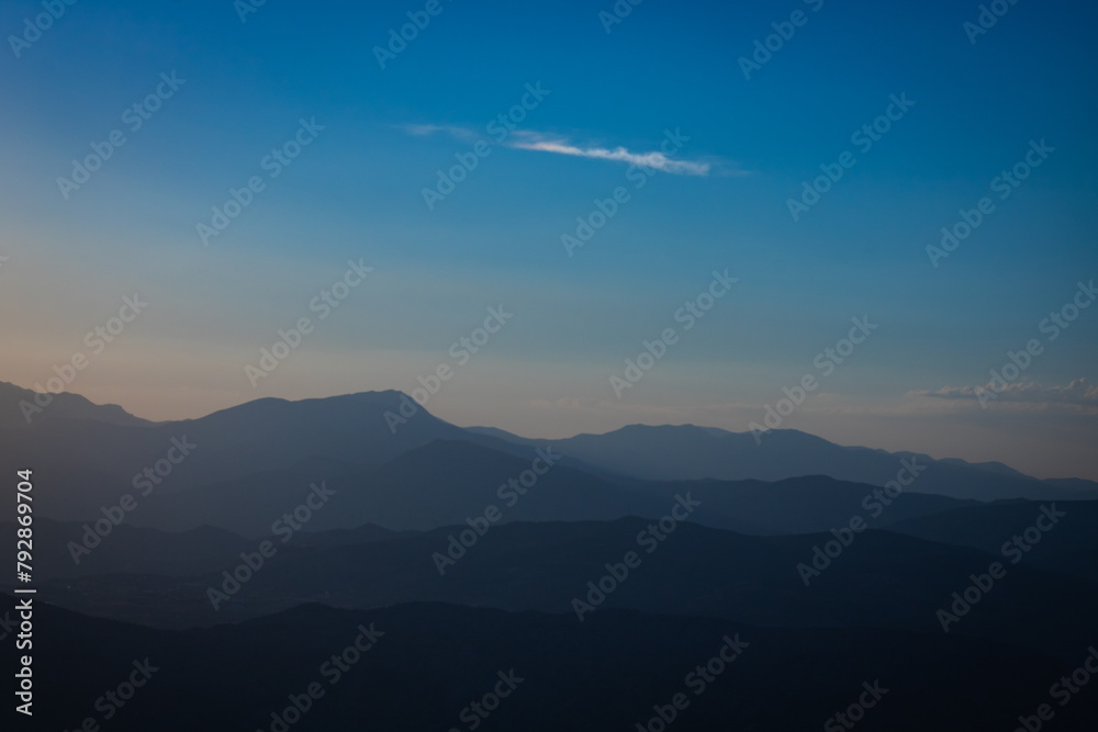 Fototapeta premium Layered silhouette of hills at sunset from Mount Nemrut