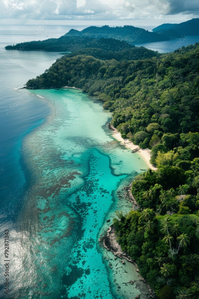 A winding coastline from above, showcasing the contrast between lush green jungle, pristine beaches