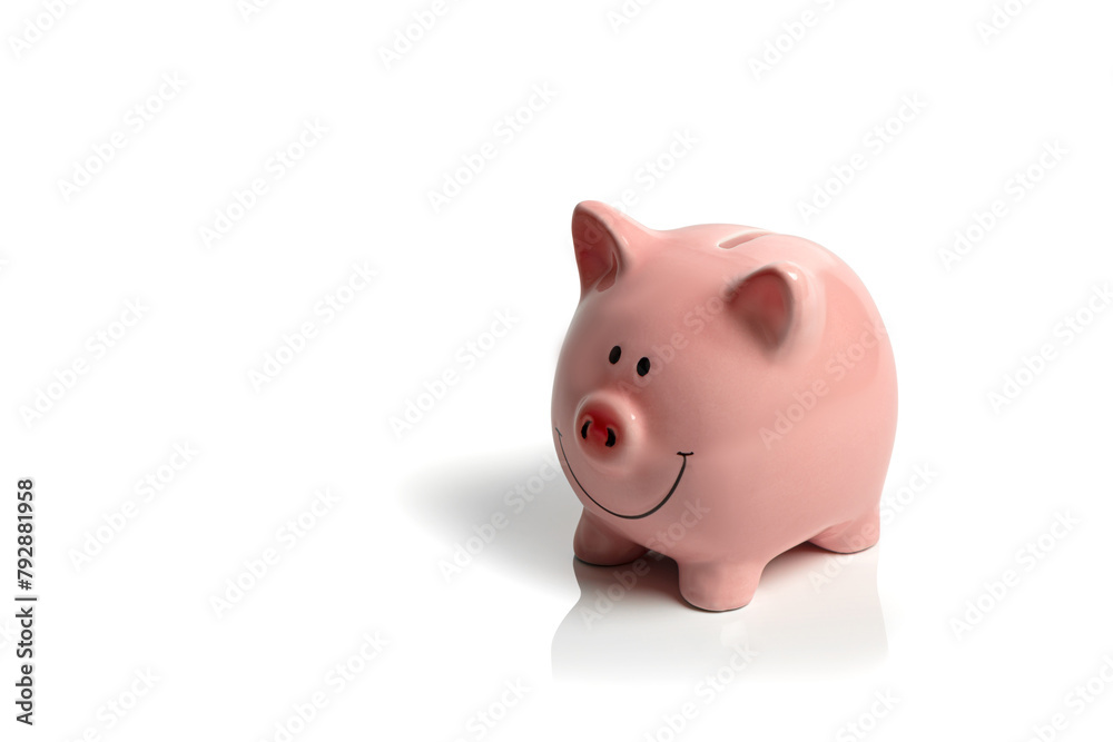 Piggy bank isolated on a white background; happy, pink piggy bank on a white background; concept image money saving, economy, cost of living with copy space.