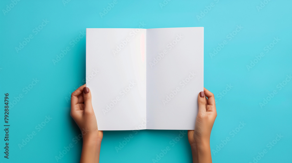 Hands hold an open blank notebook on a blue background. Copy space. Generative AI Hands hold an open blank notebook on a blue background. Copy space. Generative AI