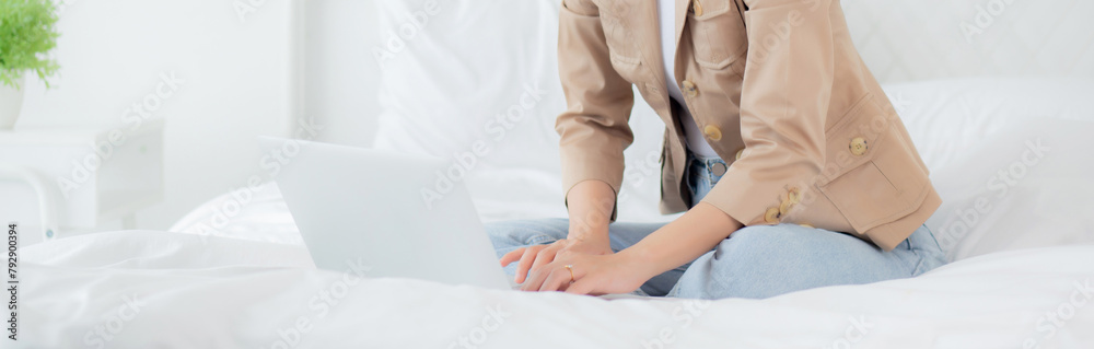 Beautiful young asian woman sitting on bed using laptop computer working from home in the bedroom, female is freelance using notebook online, one person, business and lifestyles concept. Beautiful young asian woman sitting on bed using laptop computer working from home in the bedroom, female is freelance using notebook online, one person, business and lifestyles concept.