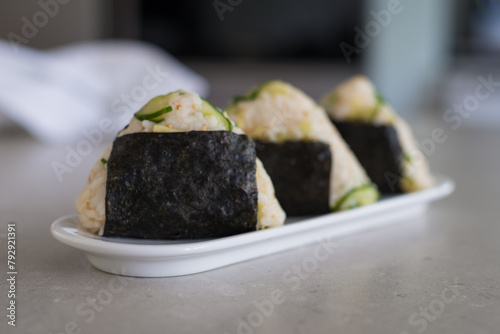 Homemade Onigiri Kyuri, rice triangle with cucumber, sesame seeds, ginger, nori seaweed (ID: 792921391)