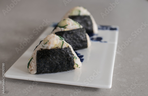 Homemade Onigiri Kyuri, rice triangle with cucumber, sesame seeds, ginger, nori seaweed (ID: 792921780)