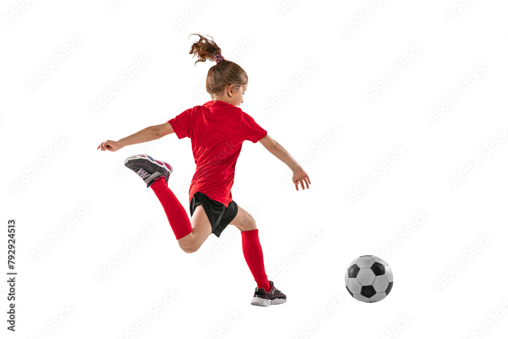 Naklejka premium Portrait of little girl in motion, training, playing football against transparent background. Sportive and active kid. Concept of action, team sport game, energy, vitality.