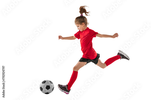 Dynamic portrait of little girl in motion, training, playing football against transparent background. Sportive and active kid. Concept of action, team sport game, energy, vitality.