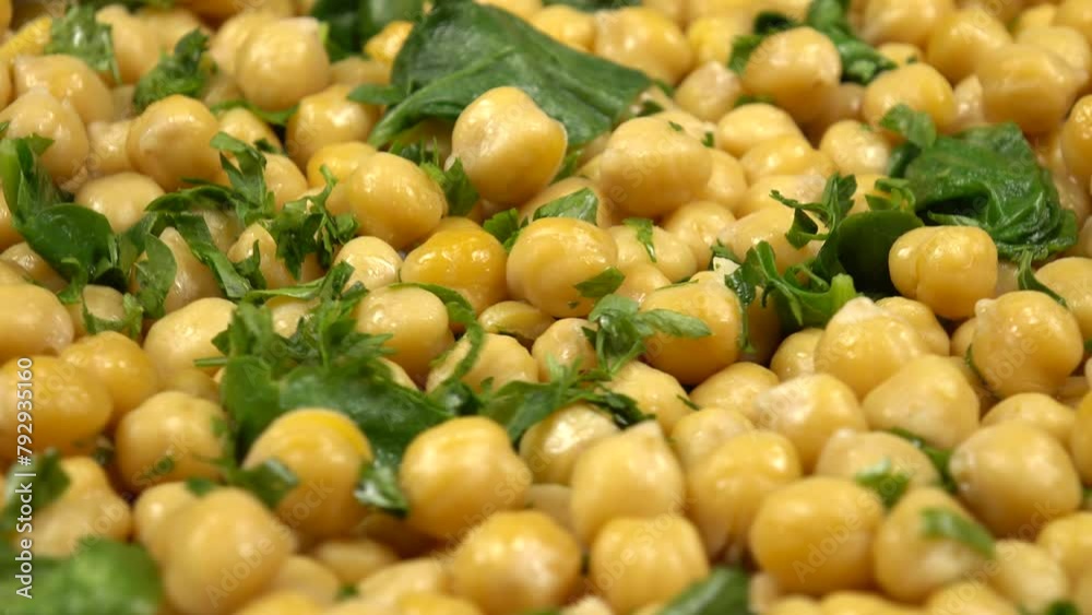 Freshly cooked boiled chick-peas sprinkling with fresh parsley and sautéed spinach leaves, background Freshly cooked boiled chick-peas sprinkling with fresh parsley and sautéed spinach leaves, background