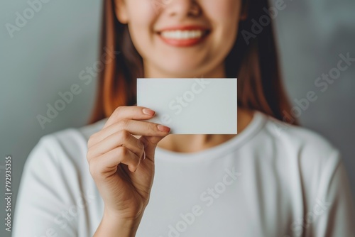 Feminine Elegance: Woman Holding Business Card with Grace