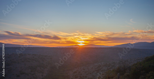 Sunrise over the green hills of the shrub savanna in southern Africa.