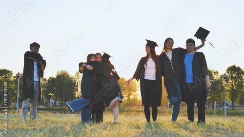 Student alumni waving at sunset. photo