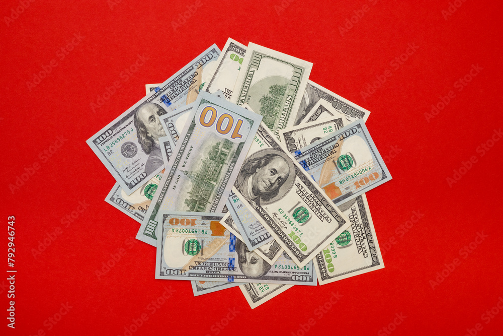 a pile of old and new dollars on a red background a pile of old and new dollars on a red background