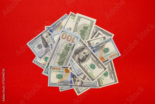 a pile of old and new dollars on a red background