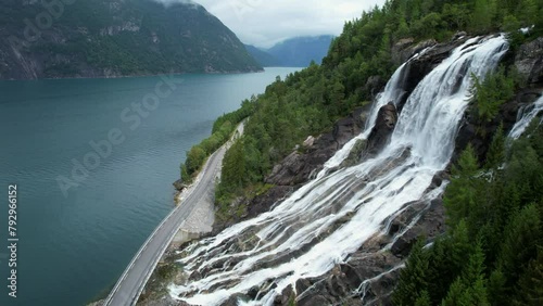 Breathtaking Scenery of Mountain Waterfall and Fjord on Both Sides of Roadway photo