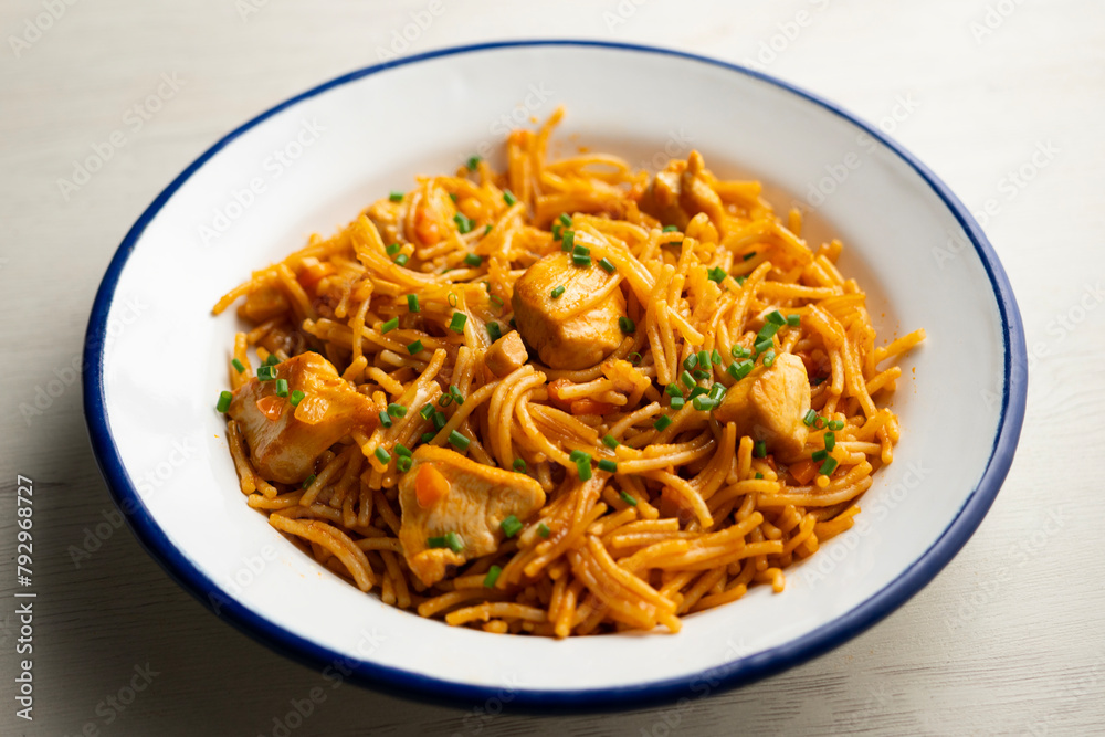 Spanish fideua paella with chicken and vegetables. Spanish fideua paella with chicken and vegetables.