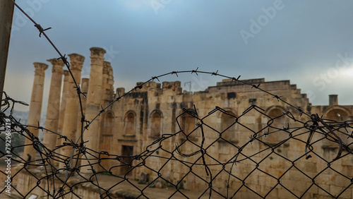 ancient ruins in jerash with barbed wire foreground, jordan
